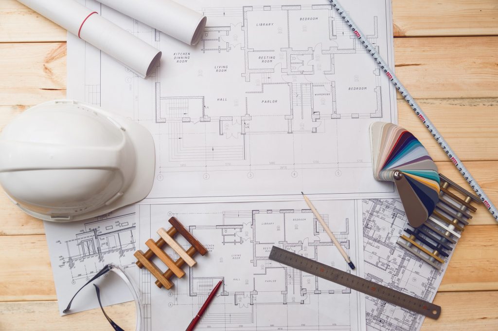 Architecture drawing desk, construction site working with blueprints in the office top view